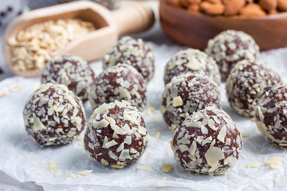 Healthy homemade paleo chocolate energy balls on parchment, horizontal